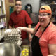 Chef Philip and Liz stand with eggs in the kitchen.