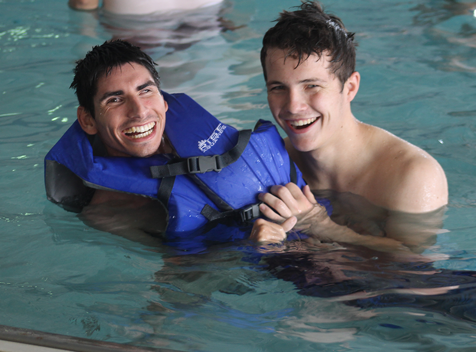 Camp Civitan staffer helping a member in the pool.